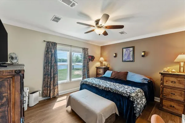 a bedroom with a large bed and a window