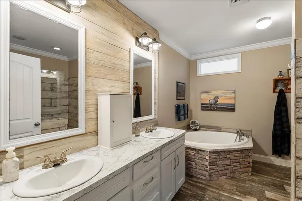 a bathroom with a sink double vanity granite and a mirror