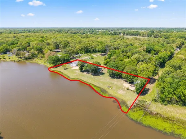 a view of a swimming pool with a yard and outdoor seating