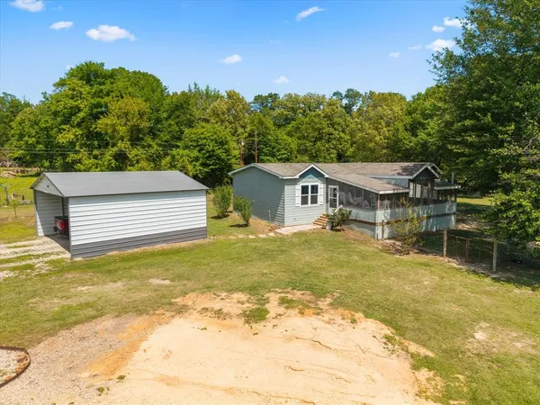 a view of a house with pool and sitting area
