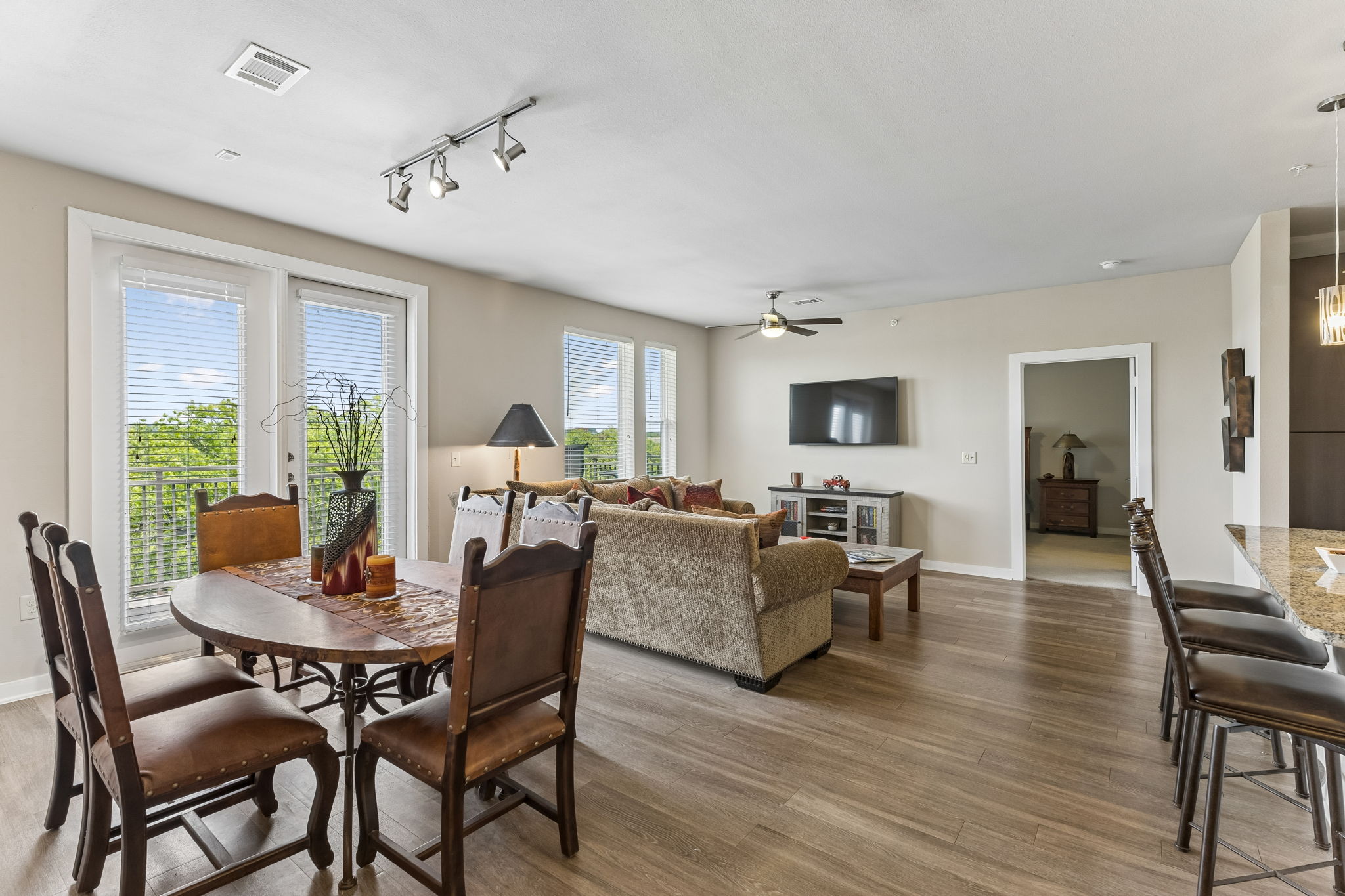 1900 Barton Springs Road, Unit 5032 Austin, TX 78704 - Photo 9 of 40 Open-concept living area featuring wood-finish flooring, recessed lighting, and balcony access
