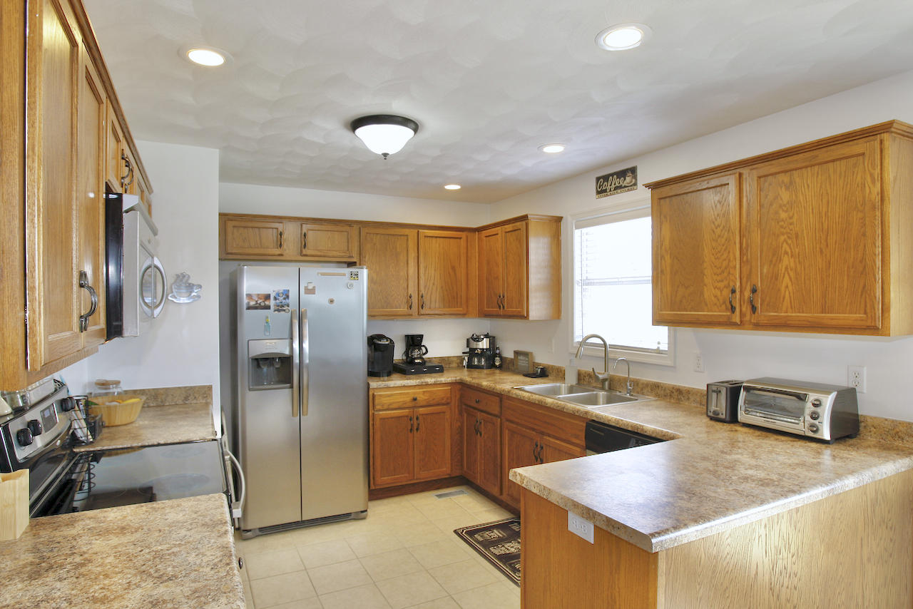 2444 Nemmo Road Vinton, VA 24179 - Photo 11 of 59 a kitchen with stainless steel appliances granite countertop a sink a stove and a refrigerator