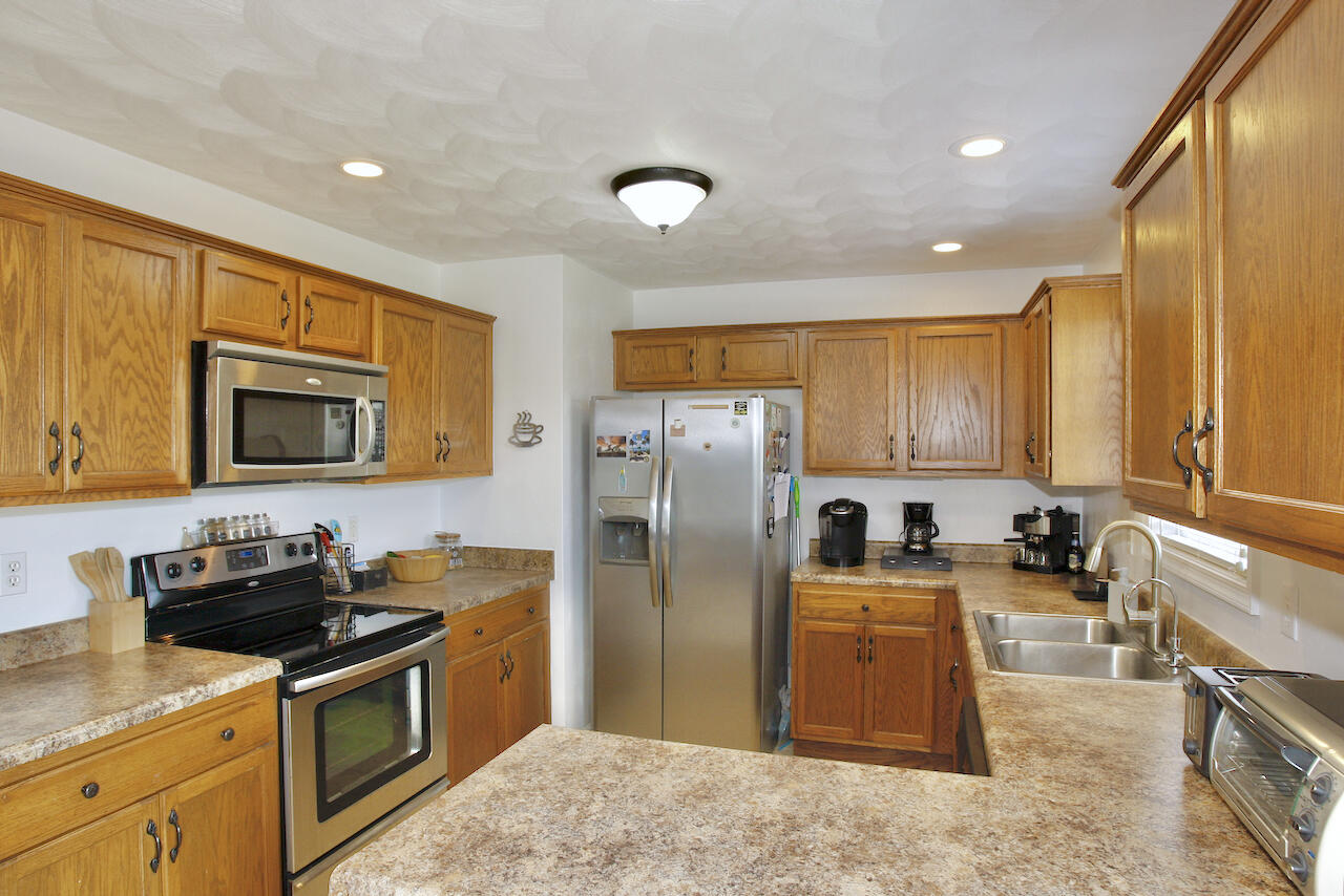 2444 Nemmo Road Vinton, VA 24179 - Photo 12 of 59 a kitchen with stainless steel appliances granite countertop a stove a sink a refrigerator and a microwave