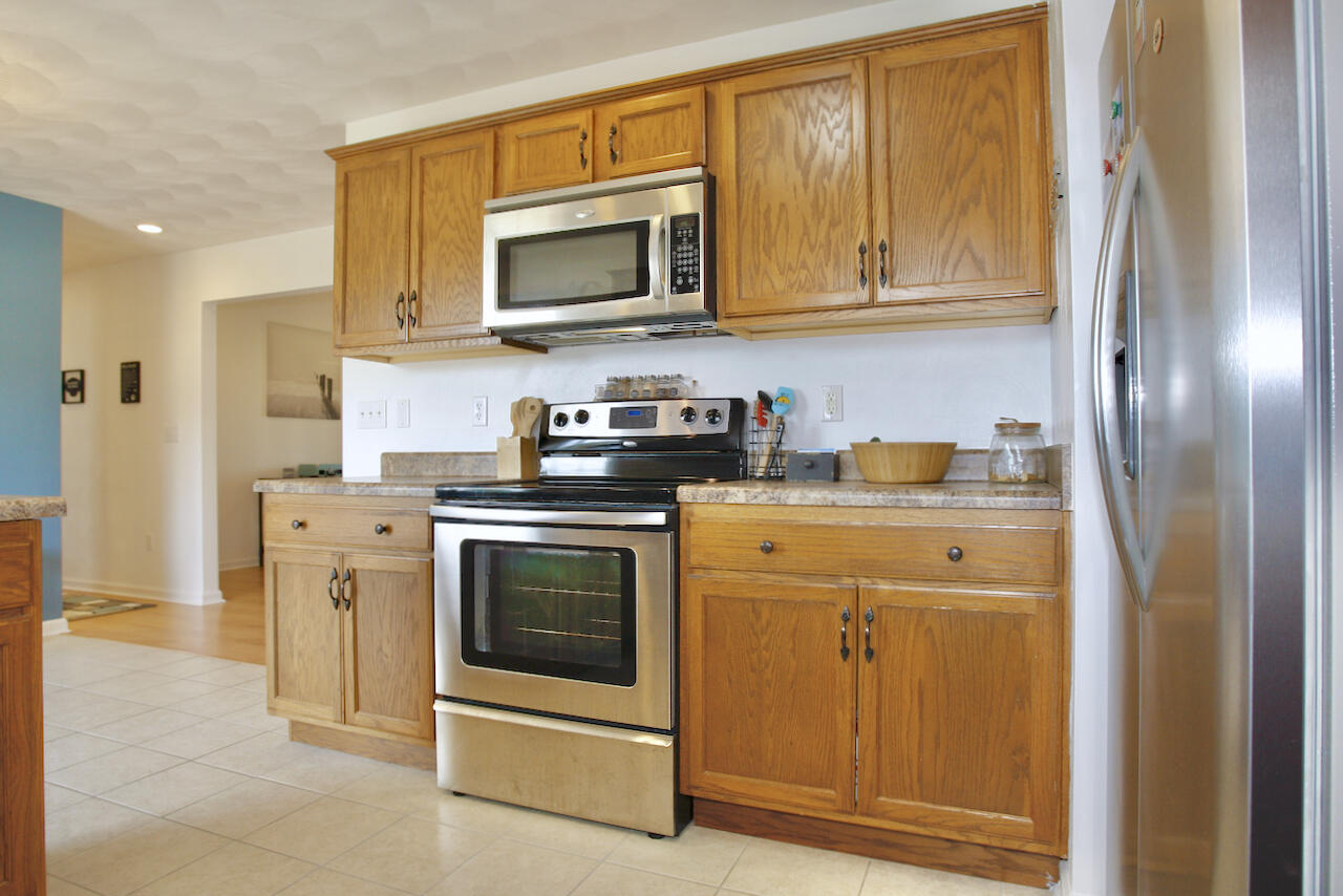 2444 Nemmo Road Vinton, VA 24179 - Photo 14 of 59 a kitchen with stainless steel appliances granite countertop a stove a microwave and a refrigerator