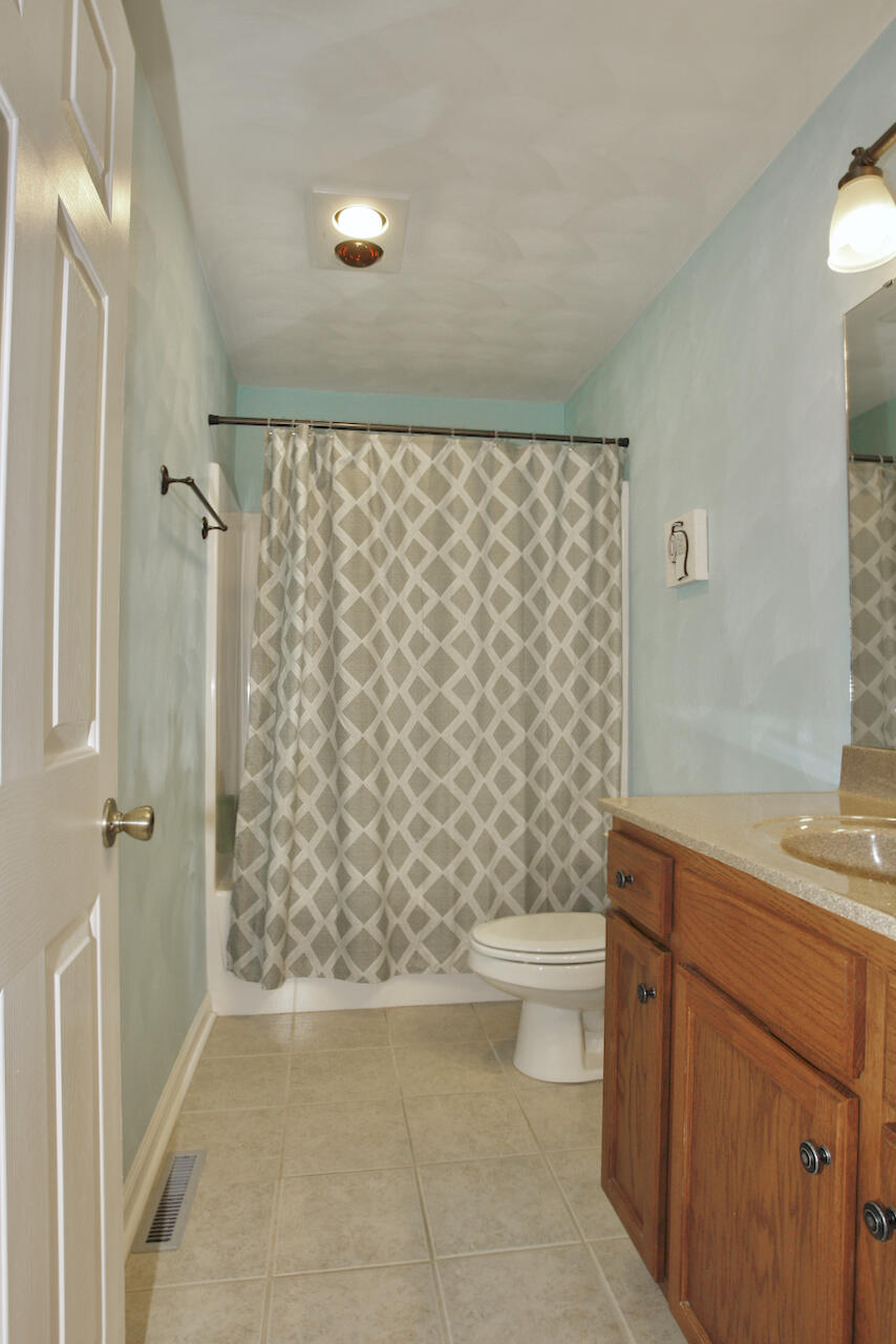 2444 Nemmo Road Vinton, VA 24179 - Photo 17 of 59 a bathroom with a shower curtain and a sink