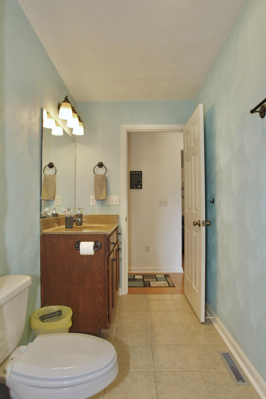 2444 Nemmo Road Vinton, VA 24179 - Photo 18 of 59 a bathroom with a granite countertop toilet sink and mirror