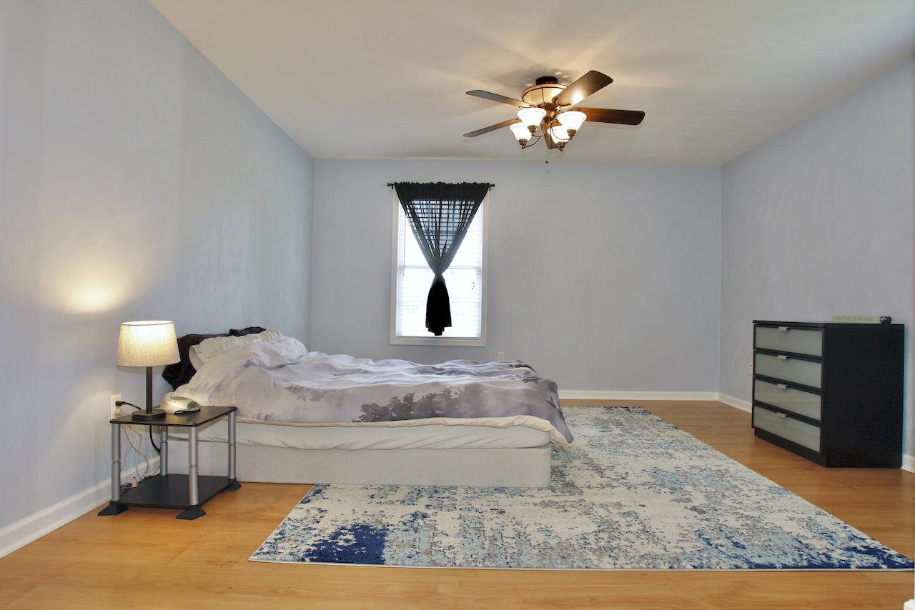 2444 Nemmo Road Vinton, VA 24179 - Photo 23 of 59 a bedroom with a bed and a chandelier