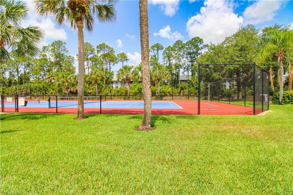 225 Robin Hood Circle, Unit 203 Naples, FL 34104 - Photo 50 of 50 View of home's community with a lawn and tennis court