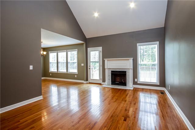 95 Brummitt Road Castalian Springs, TN 37031 - Photo 2 of 16 Great open living room with fireplace and french door opening out to the deck.