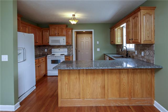 95 Brummitt Road Castalian Springs, TN 37031 - Photo 4 of 16 Beautiful Kitchen with granite countertops, tile backsplash, hardwood floors, and copper sink!