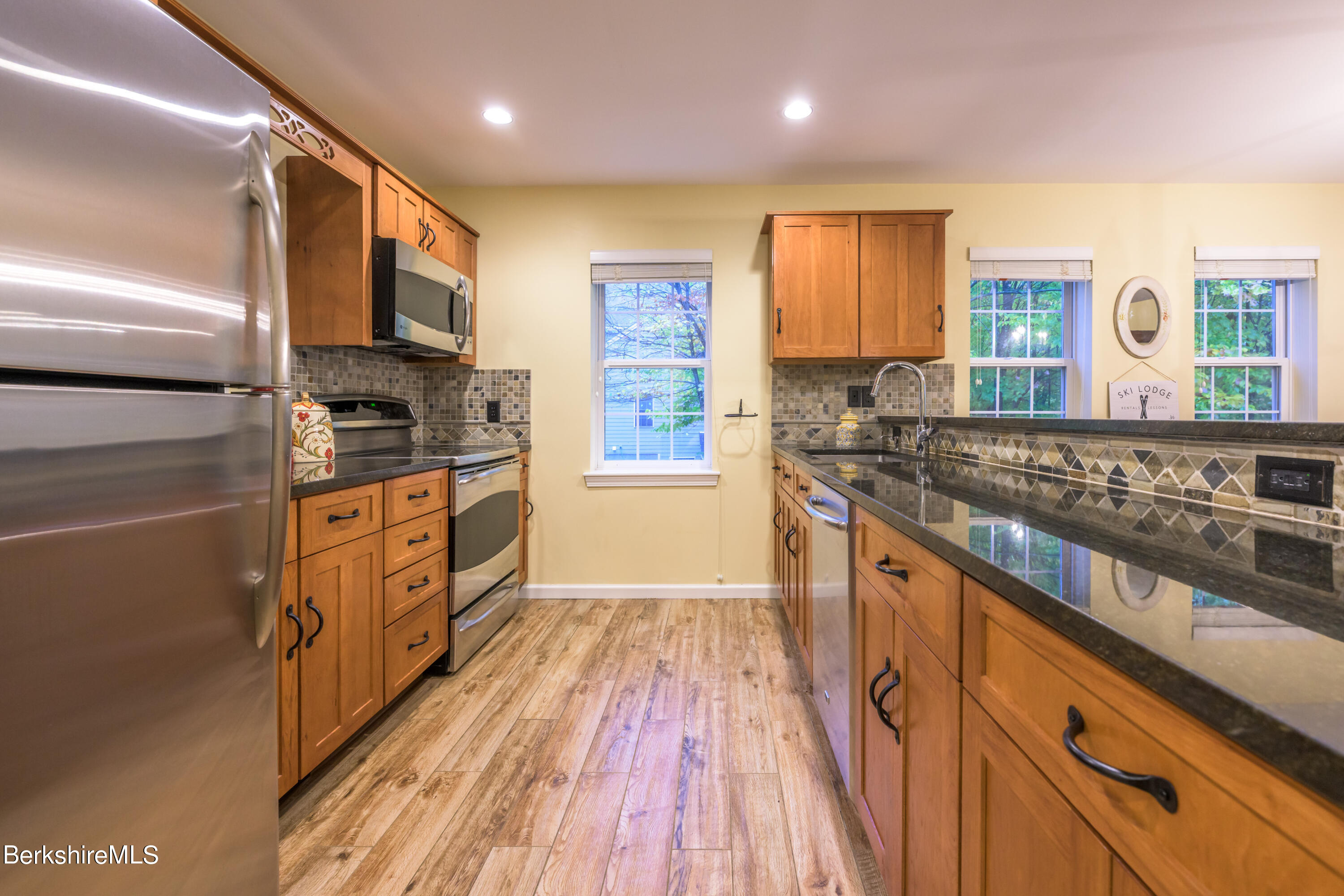 9341 Mountainside Drive Hancock, MA 01237 - Photo 13 of 43 a kitchen with stainless steel appliances granite countertop a stove and a sink