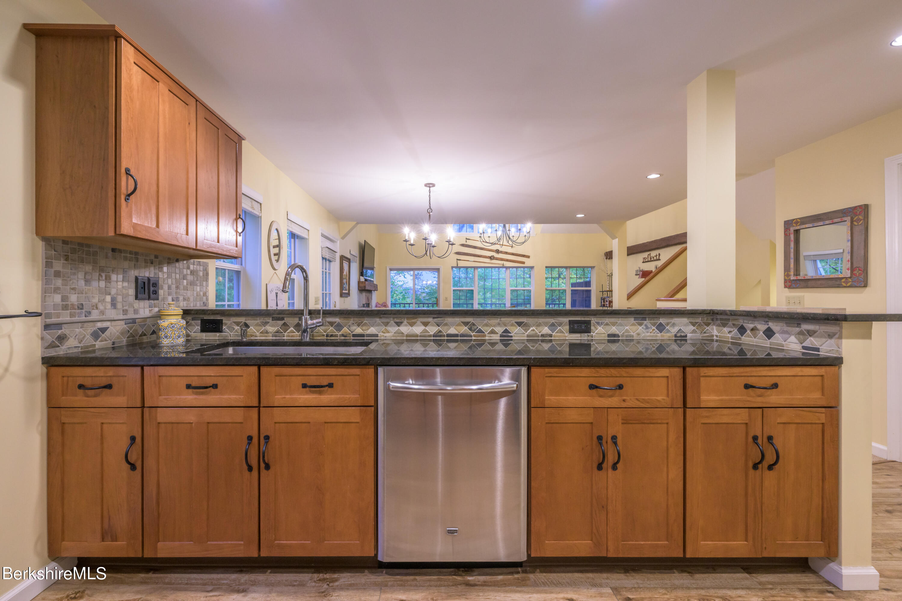 9341 Mountainside Drive Hancock, MA 01237 - Photo 14 of 43 a kitchen with granite countertop a stove a sink and a wooden cabinets