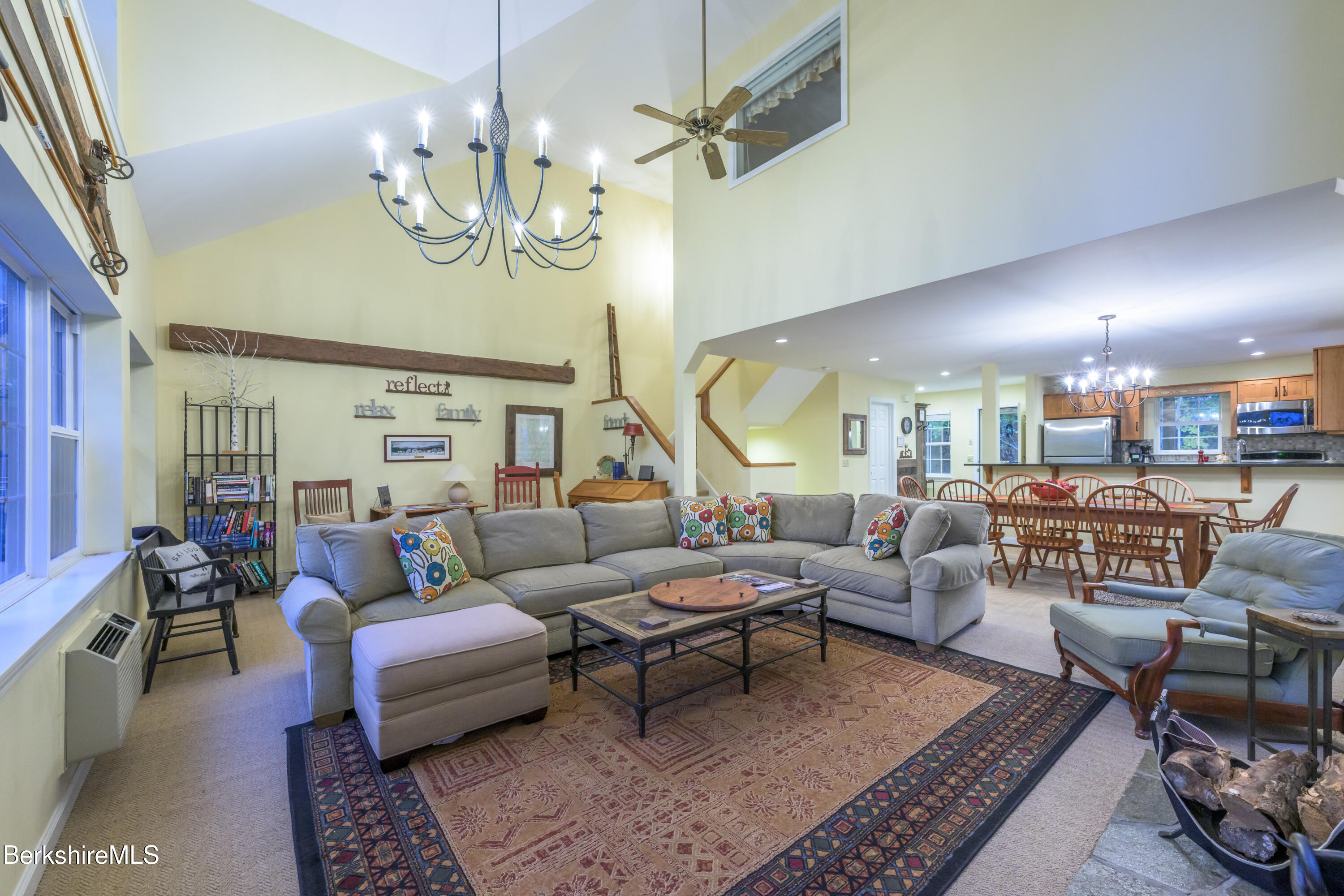 9341 Mountainside Drive Hancock, MA 01237 - Photo 20 of 43 a living room with lots of furniture and a chandelier