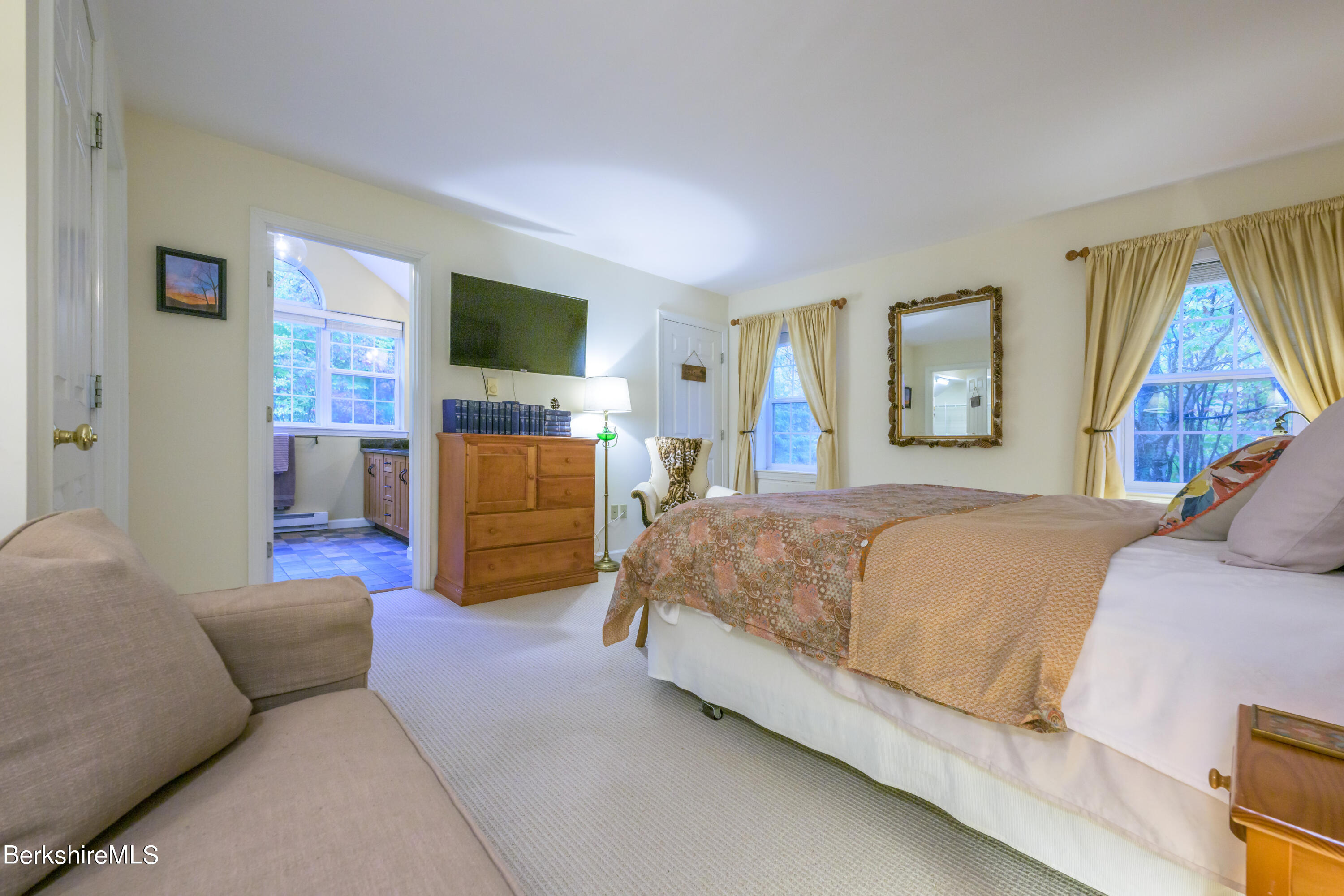 9341 Mountainside Drive Hancock, MA 01237 - Photo 25 of 43 a spacious bedroom with a bed and a flat screen tv