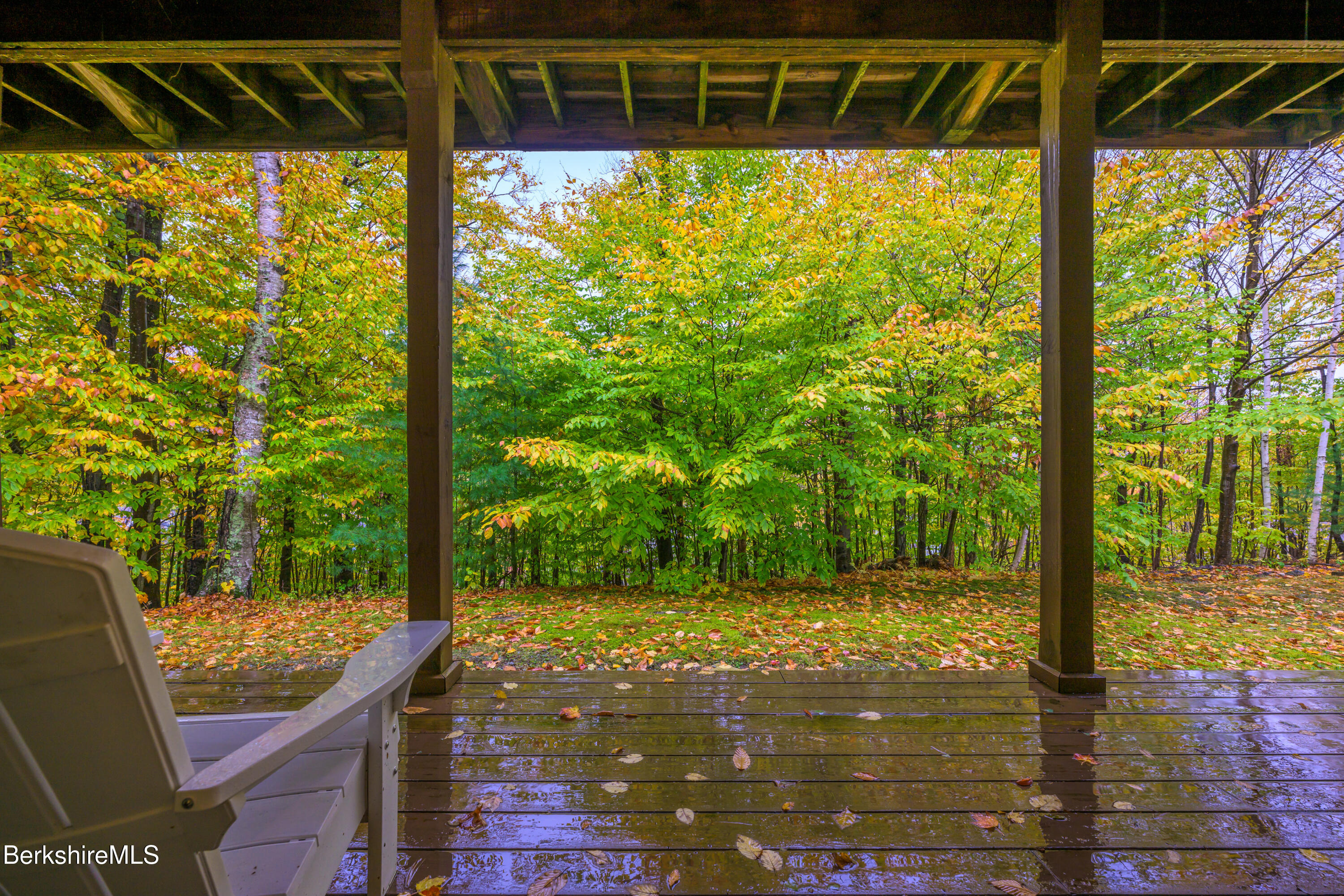 9341 Mountainside Drive Hancock, MA 01237 - Photo 38 of 43 a view of a porch with a floor to ceiling window next to a yard