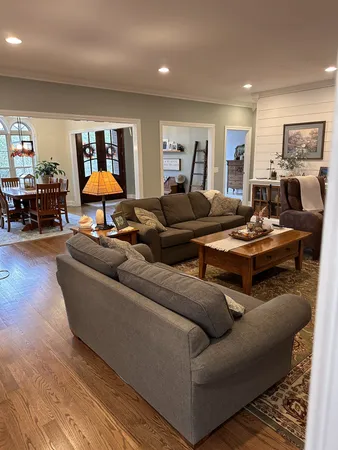 a living room with furniture and a wooden floor