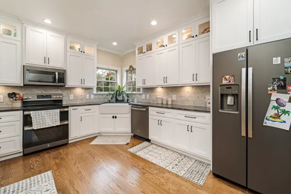 a kitchen with stainless steel appliances granite countertop a refrigerator sink and stove