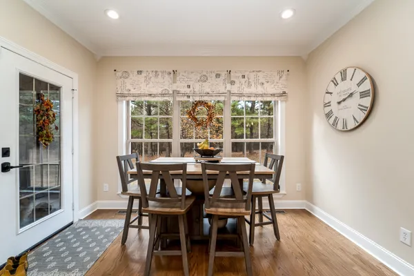 a view of a dining room with furniture window and wooden floor
