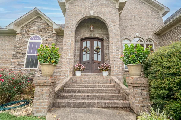 a front view of a house with potted plants