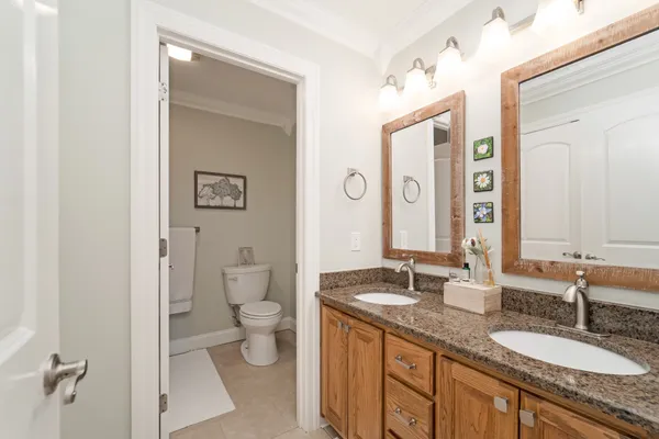 a bathroom with a granite countertop sink double and a mirror