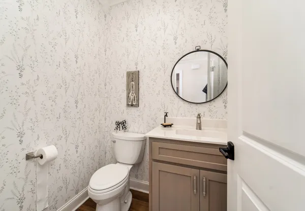 a bathroom with a toilet a sink and mirror