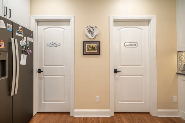 a view of a hallway with wooden floor