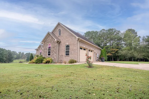 a big house with a big yard and large trees