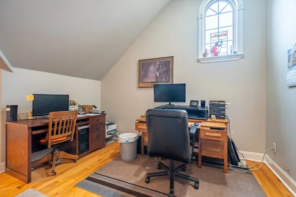 a view of a workspace with furniture and a window