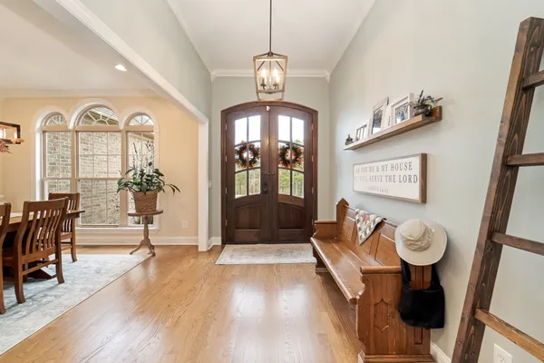 a view of a livingroom with furniture wooden floor and a chandelier