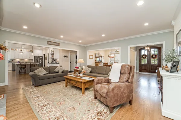 a living room with furniture and wooden floor