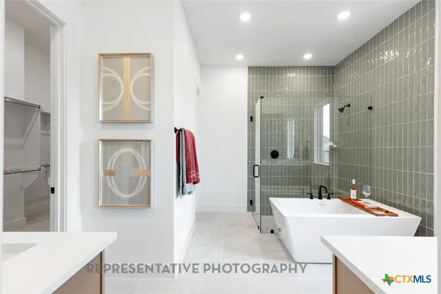 a kitchen with stainless steel appliances granite countertop white cabinets sink and a granite counter top