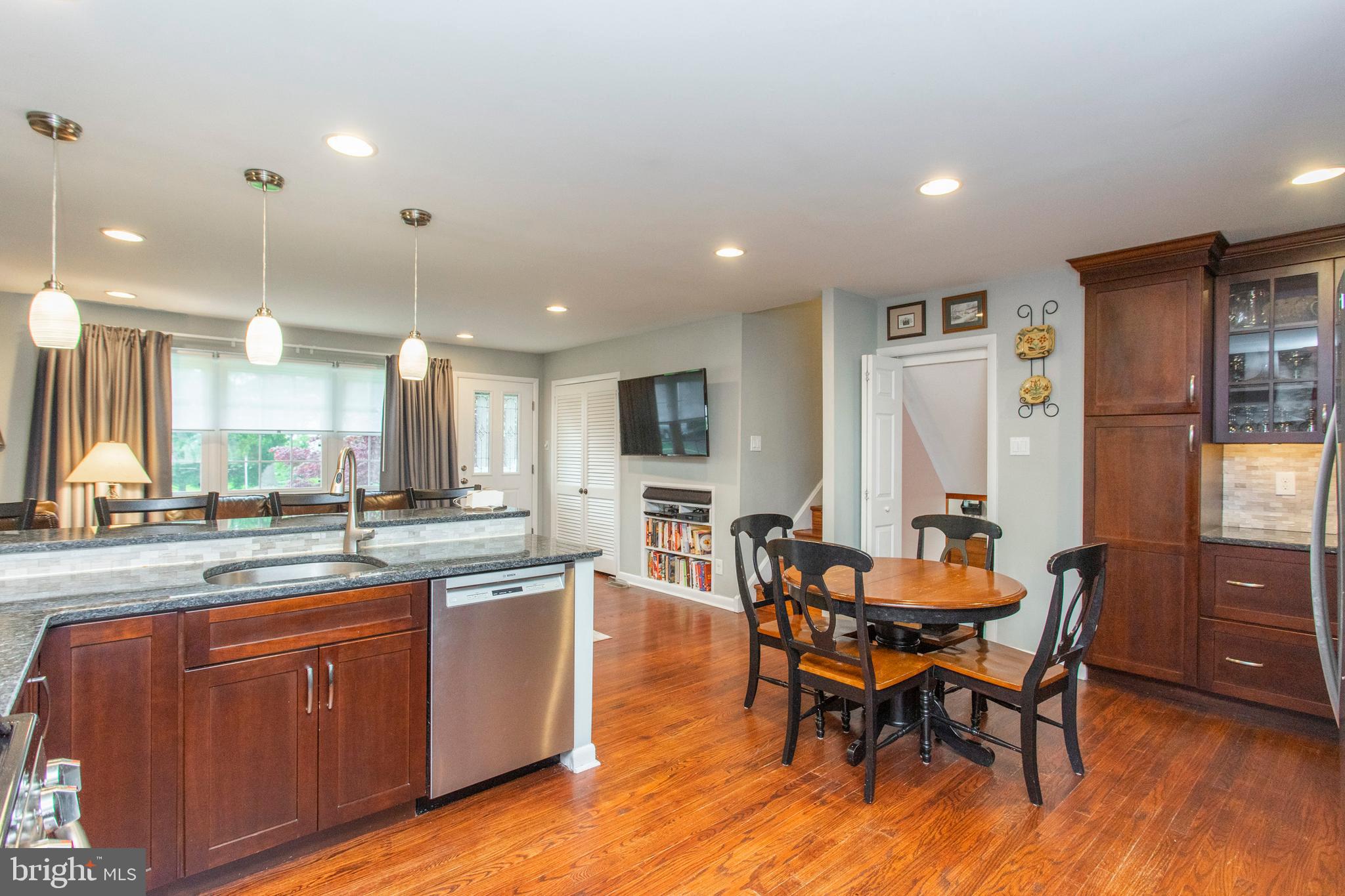 508 Exton Road Hatboro, PA 19040 - Photo 23 of 36 a kitchen with stainless steel appliances granite countertop dining table chairs and wooden floor