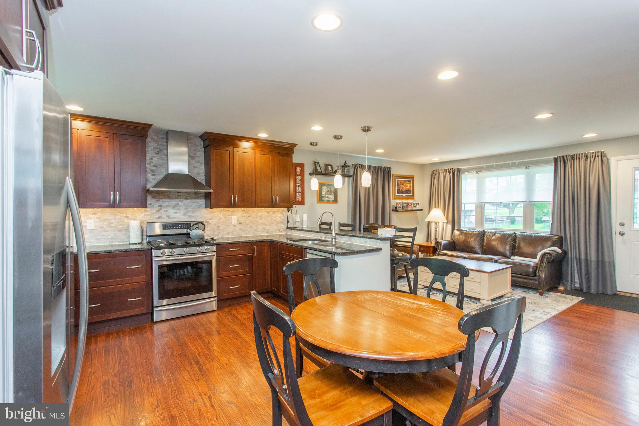 508 Exton Road Hatboro, PA 19040 - Photo 24 of 36 a kitchen with stainless steel appliances granite countertop wooden cabinets a stove a sink a dining table and chairs