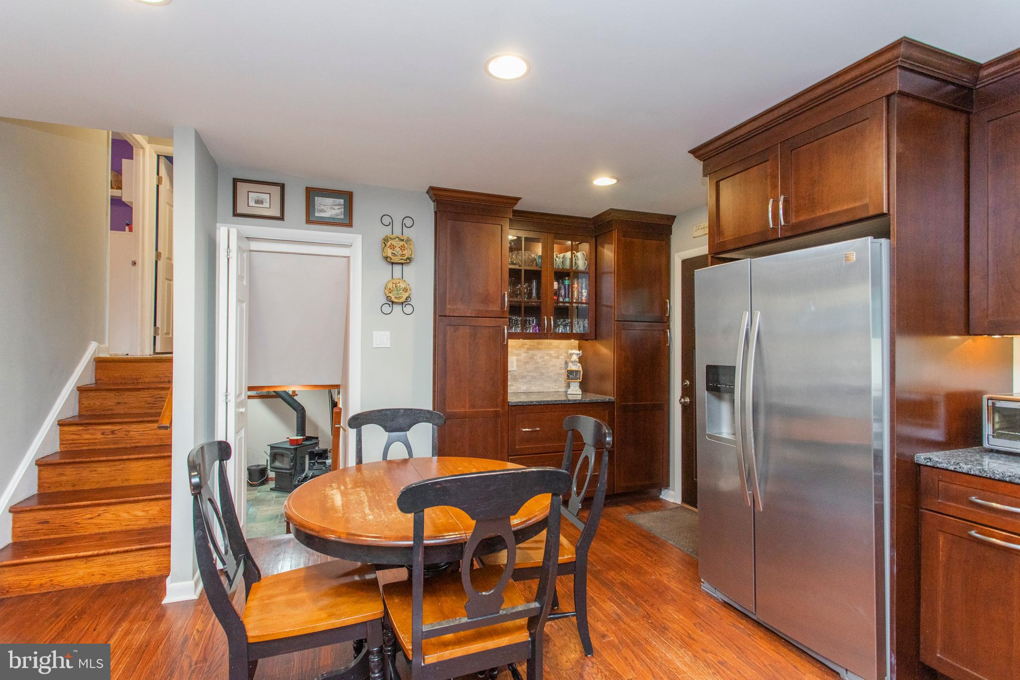 508 Exton Road Hatboro, PA 19040 - Photo 26 of 36 a kitchen with stainless steel appliances a refrigerator a stove a dining table and chairs with wooden floor
