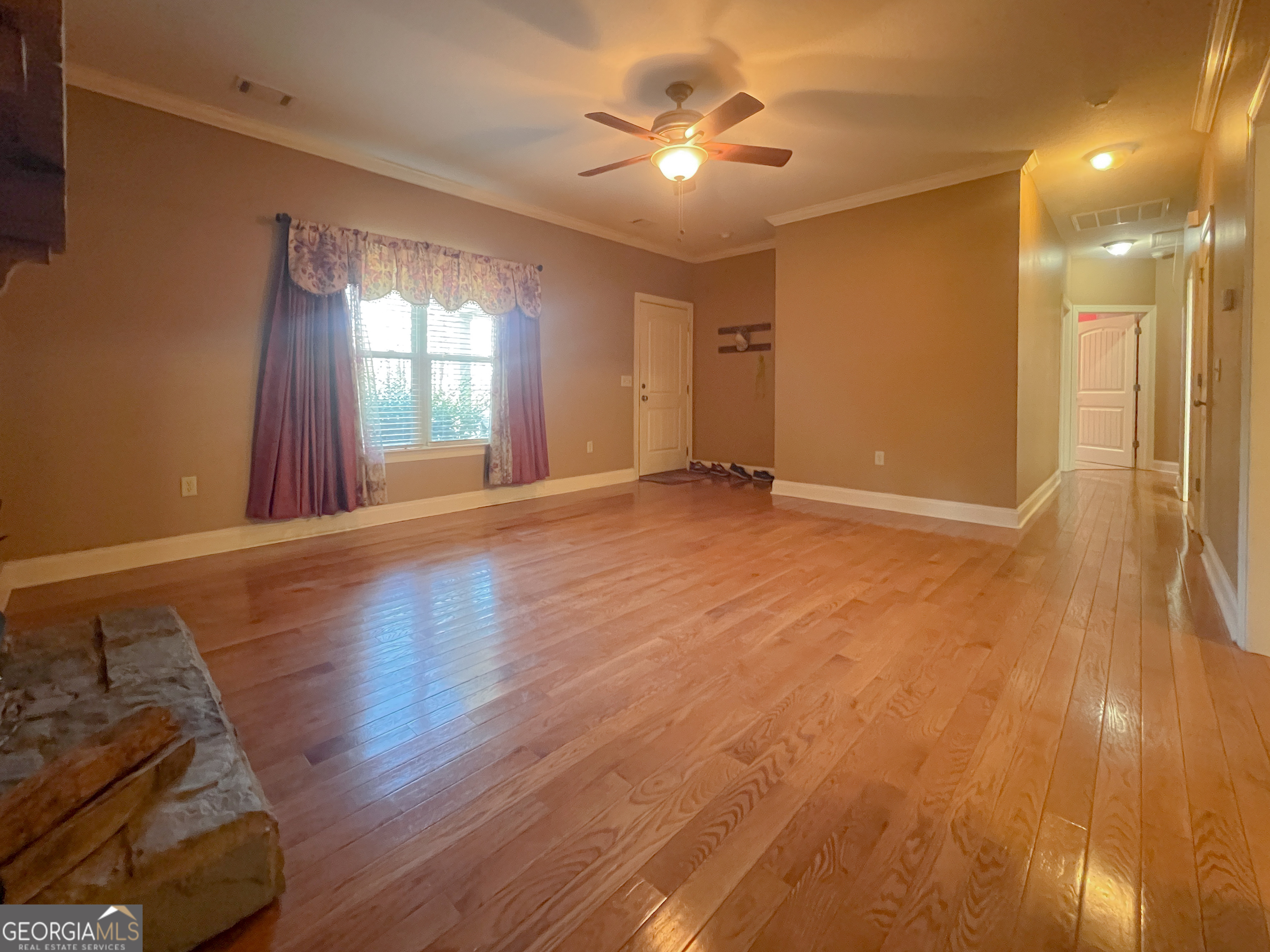 1610 Clifton Road Statesboro, GA 30458 - Photo 11 of 37 a view of an empty room with window and wooden floor