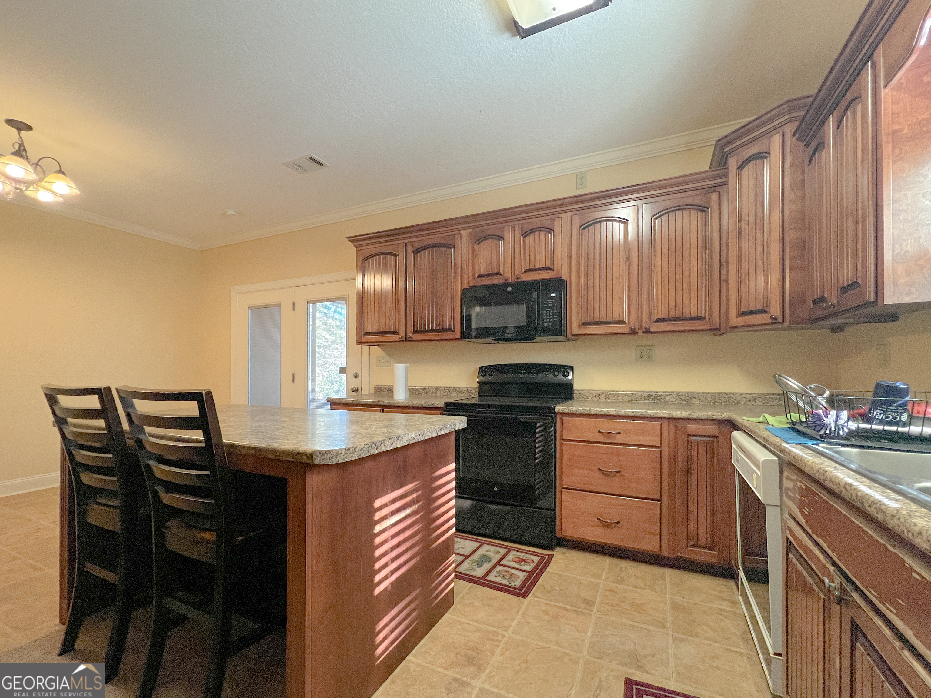 1610 Clifton Road Statesboro, GA 30458 - Photo 16 of 37 a kitchen with a sink a stove and cabinets