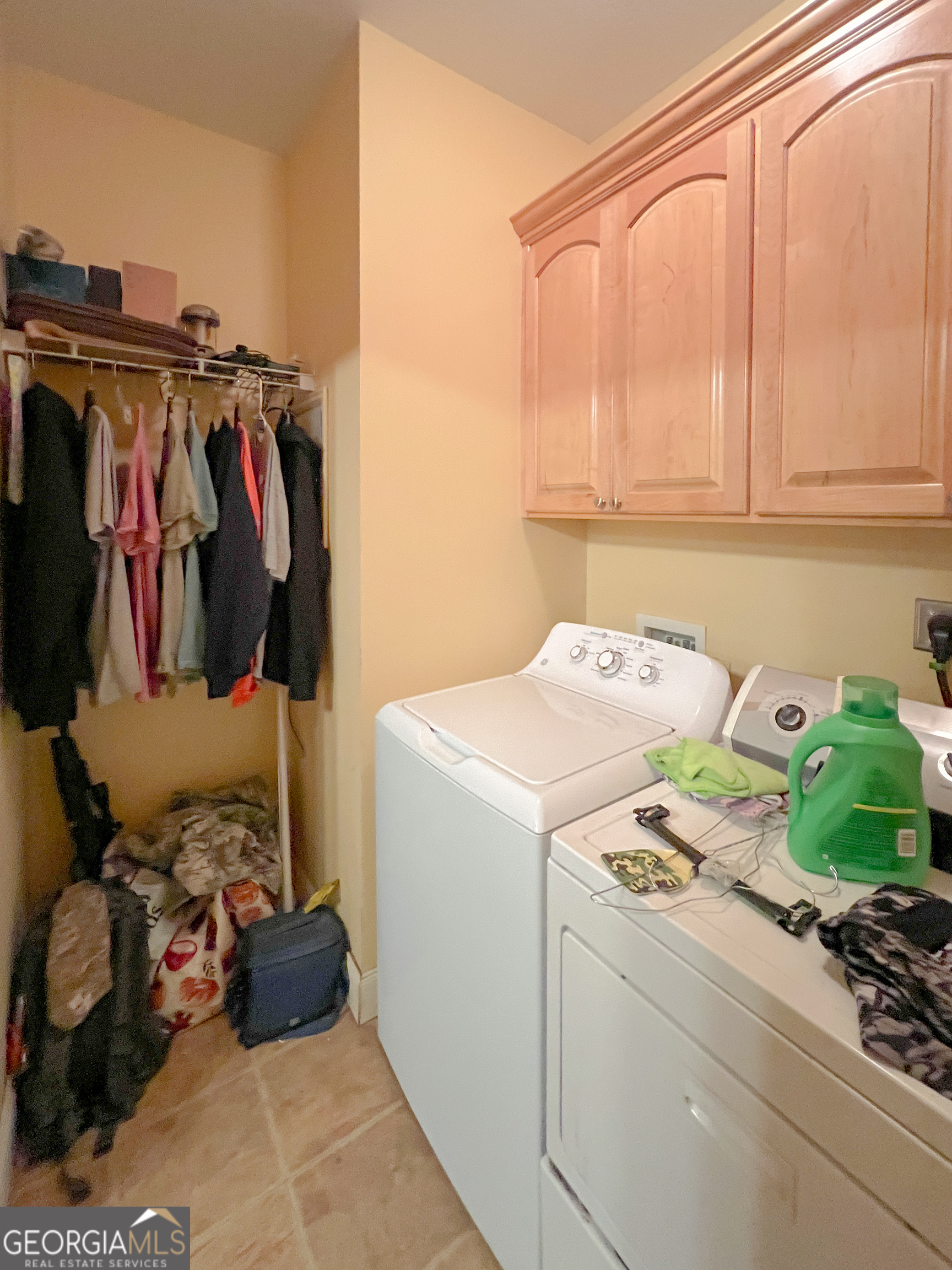 1610 Clifton Road Statesboro, GA 30458 - Photo 19 of 37 a view of walk in closet with clothes and shoes