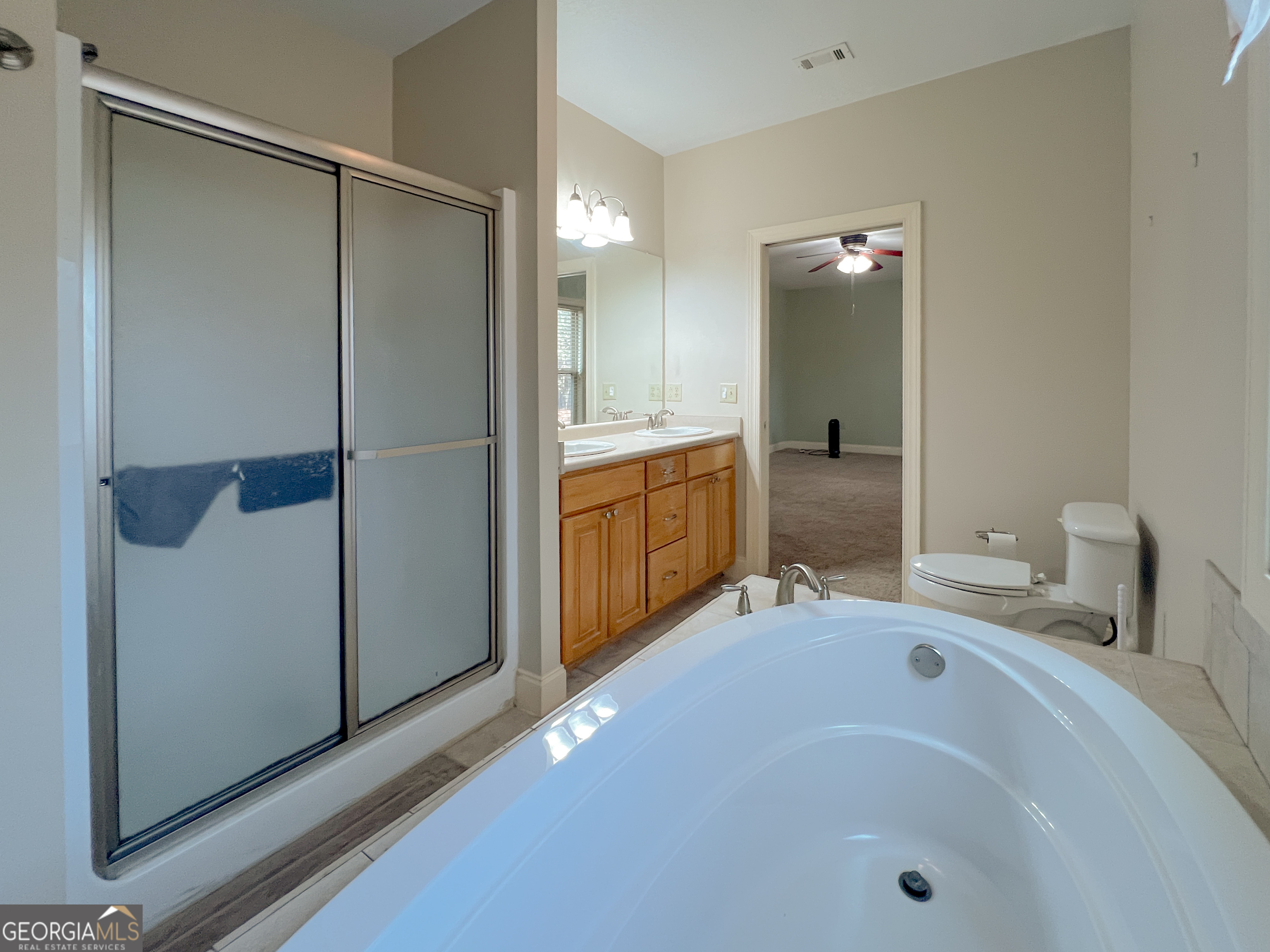 1610 Clifton Road Statesboro, GA 30458 - Photo 33 of 37 a bathroom with a tub sink and mirror