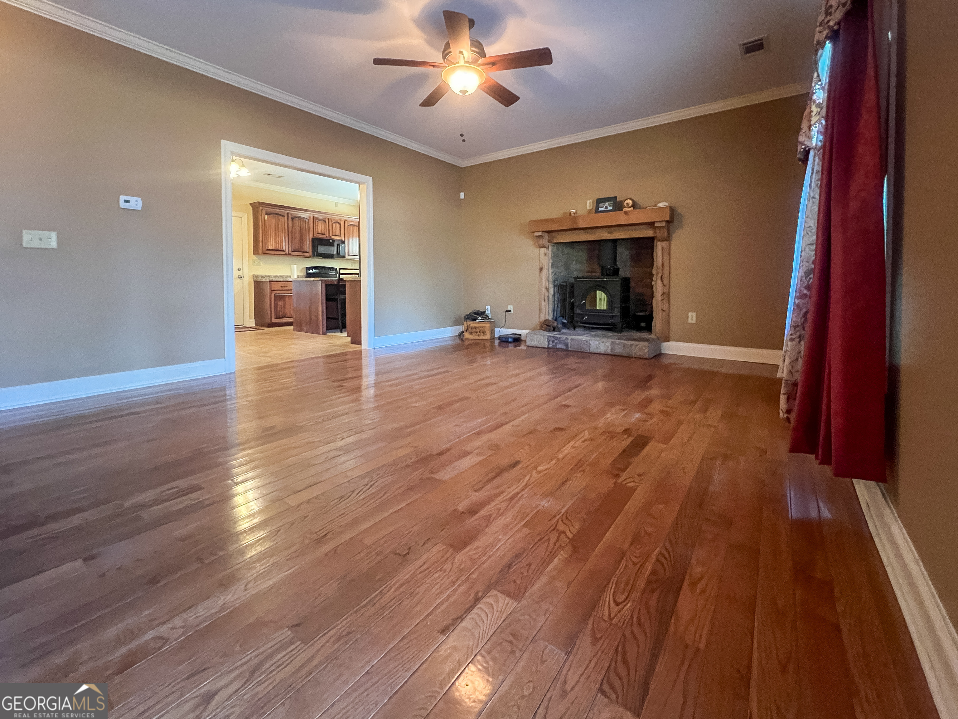 1610 Clifton Road Statesboro, GA 30458 - Photo 10 of 37 wooden floor fireplace and natural light in room