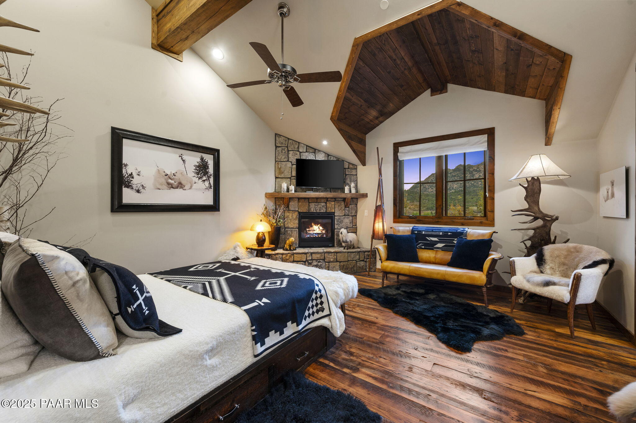 7520 North Williamson Valley Road Prescott, AZ 86305 - Photo 12 of 57 a living room with furniture a flat screen tv and a fireplace
