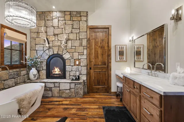 a view of a patio with couches chairs dining table and chairs barbeque grill with a small yard and large trees