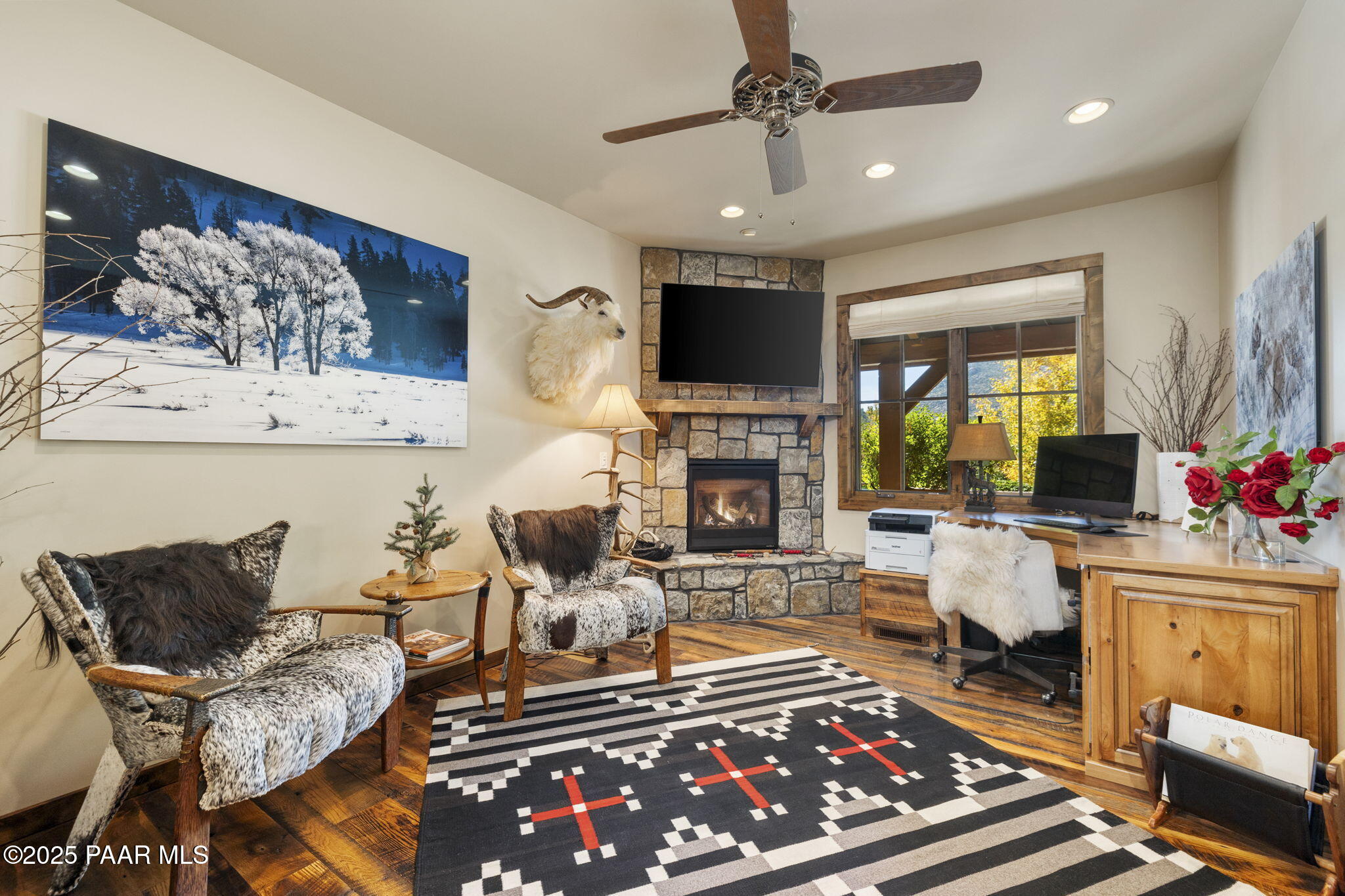 7520 North Williamson Valley Road Prescott, AZ 86305 - Photo 18 of 57 a living room with furniture a flat screen tv and a fireplace