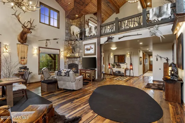 a living room with furniture a fireplace and a table