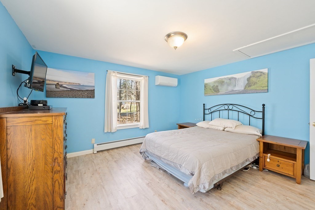 107 Brookfield Road Sturbridge, MA 01518 - Photo 12 of 36 a bedroom with a bed and wooden floor