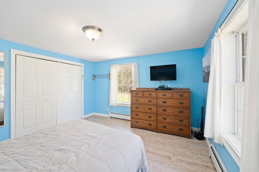 107 Brookfield Road Sturbridge, MA 01518 - Photo 13 of 36 a bedroom with a bed and a flat screen tv