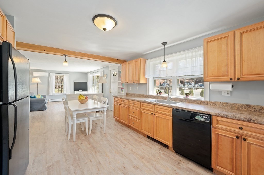 107 Brookfield Road Sturbridge, MA 01518 - Photo 2 of 36 a kitchen with stainless steel appliances granite countertop a sink dishwasher a stove a refrigerator with island and chairs
