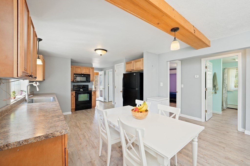107 Brookfield Road Sturbridge, MA 01518 - Photo 4 of 36 a view of a dining table and chairs in the kitchen