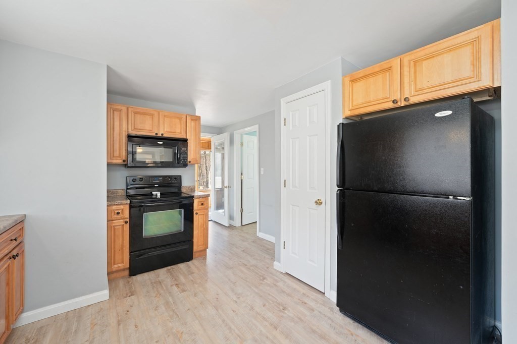 107 Brookfield Road Sturbridge, MA 01518 - Photo 5 of 36 a kitchen with stainless steel appliances a refrigerator and a stove top oven
