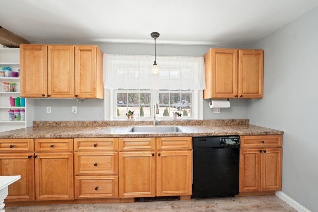 107 Brookfield Road Sturbridge, MA 01518 - Photo 6 of 36 a kitchen with granite countertop wood cabinets and a sink