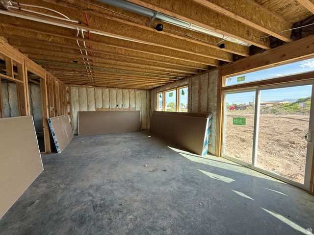 3318 South 1000 West Logan, UT 84321 - Photo 5 of 12 Unfinished basement space featuring exposed wood framing, concrete flooring, and multiple windows